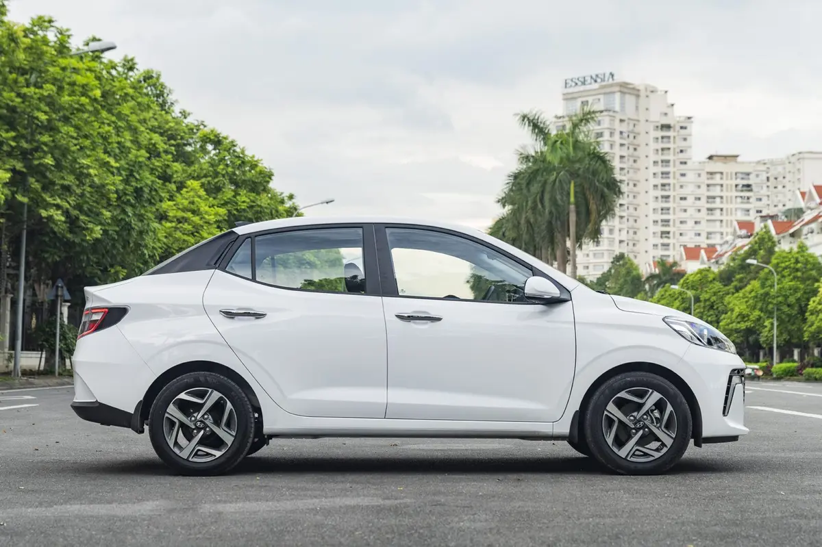 Hình ảnh chuyên gia đang kiểm tra động cơ hoặc nội thất của một chiếc Hyundai i10 cũ.